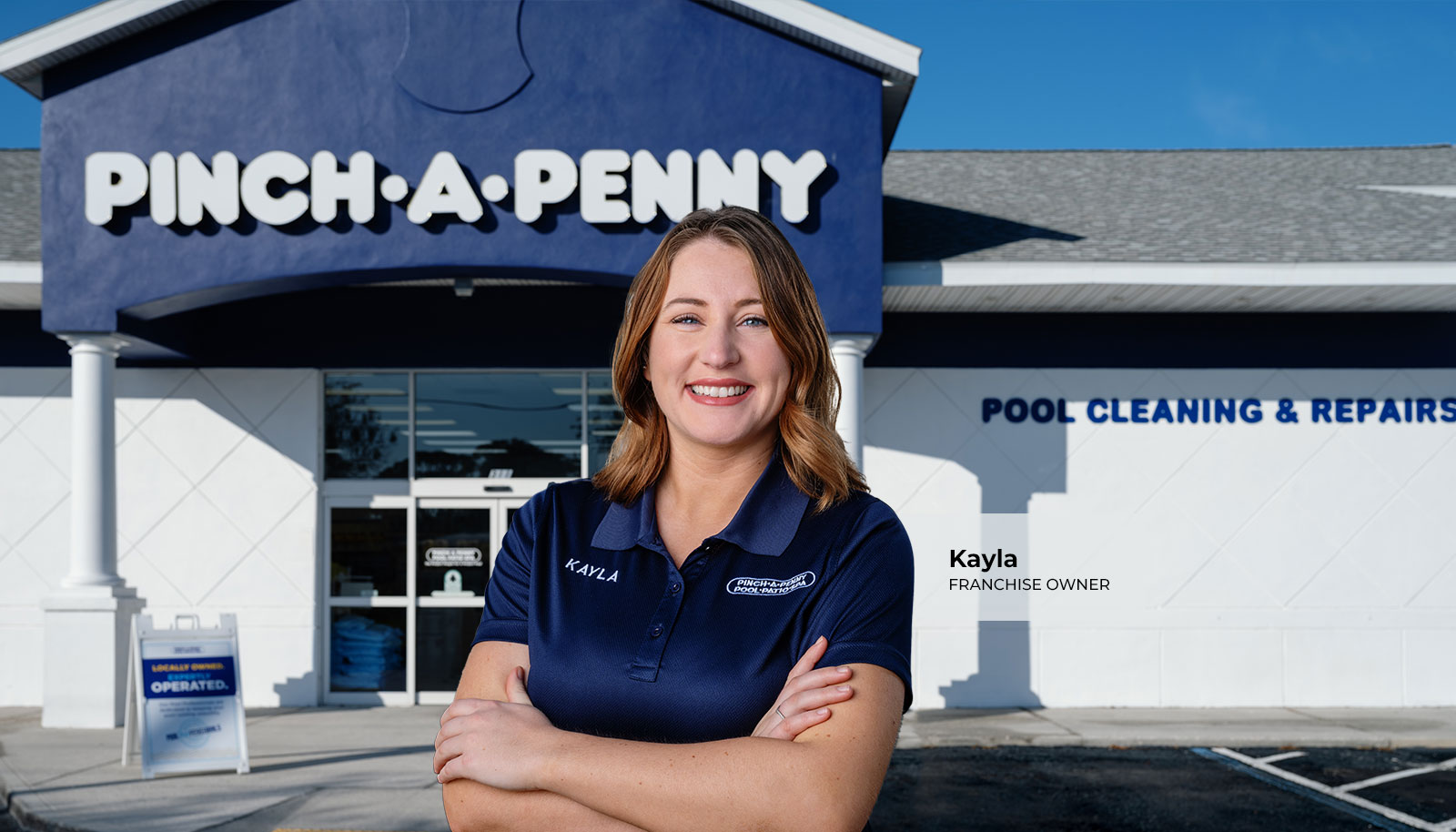 Pinch A Penny franchise owner(s) standing in front of their store.